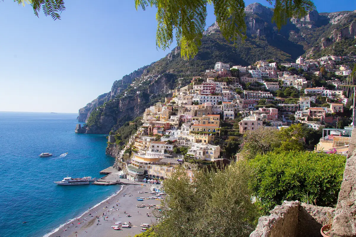 Pastel houses terraced down the cliffside to the beach and blue sea at Positano on the Amalfi Coast, Italy